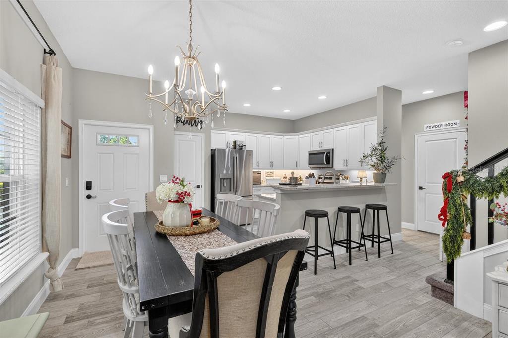 3417 Gallia Street New Smyrna Beach, FL 32168 - Photo 12 of 52 a view of a dining room with furniture kitchen and chandelier