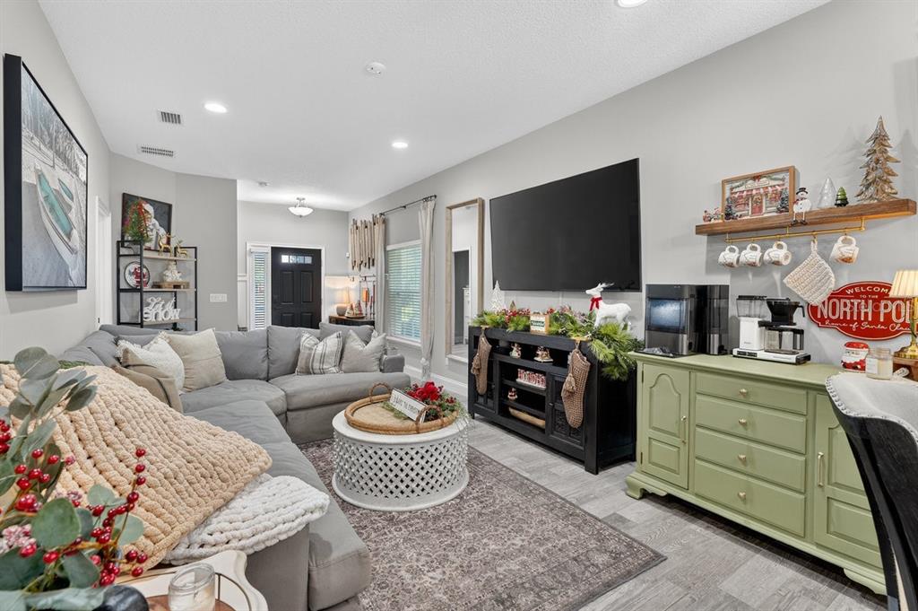3417 Gallia Street New Smyrna Beach, FL 32168 - Photo 18 of 52 a living room with furniture and a flat screen tv
