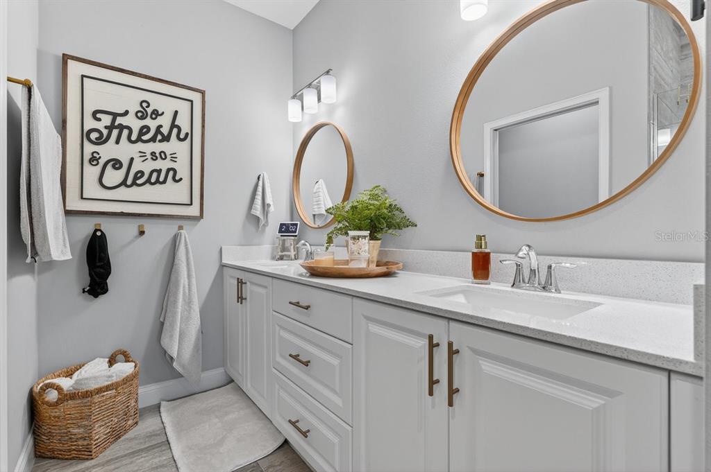 3417 Gallia Street New Smyrna Beach, FL 32168 - Photo 24 of 52 a bathroom with a sink and a mirror