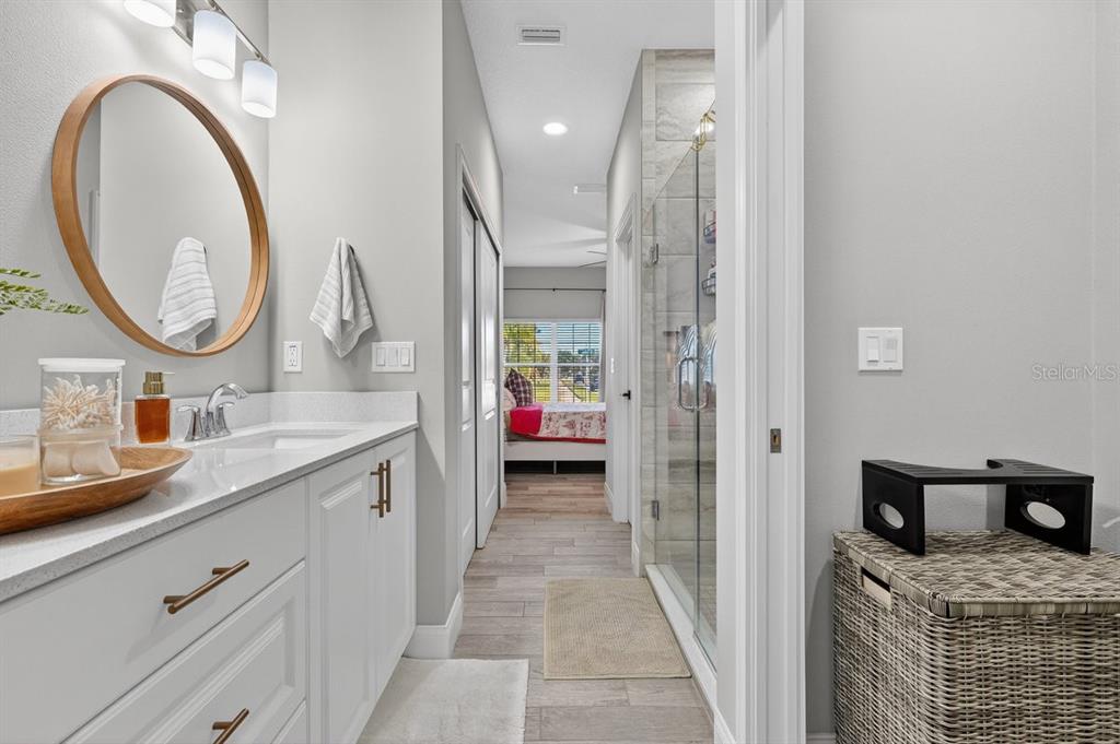 3417 Gallia Street New Smyrna Beach, FL 32168 - Photo 25 of 52 a en suite bathroom with a granite countertop sink and a mirror