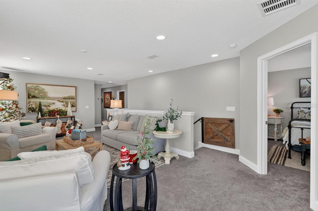 3417 Gallia Street New Smyrna Beach, FL 32168 - Photo 29 of 52 a living room with furniture and a dining table with kitchen view