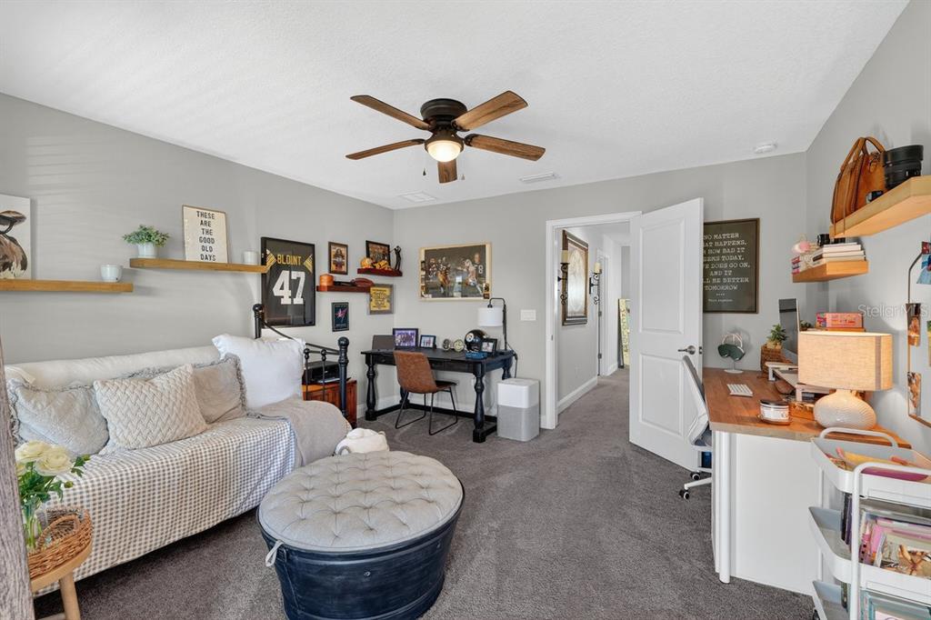 3417 Gallia Street New Smyrna Beach, FL 32168 - Photo 42 of 52 a living room with furniture a rug and a chandelier