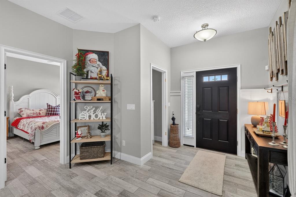 3417 Gallia Street New Smyrna Beach, FL 32168 - Photo 10 of 52 a bedroom with furniture and wooden floor