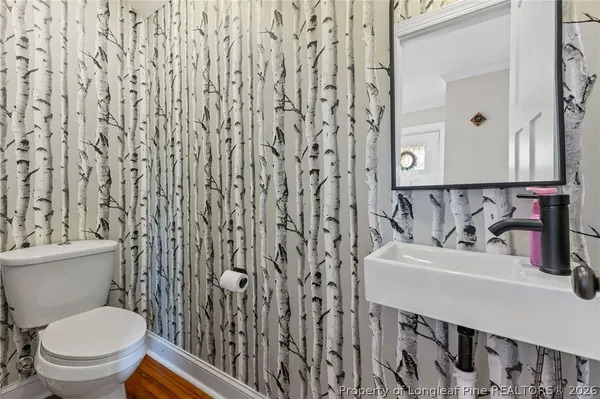 a kitchen with stainless steel appliances granite countertop a refrigerator a stove and a wooden floors