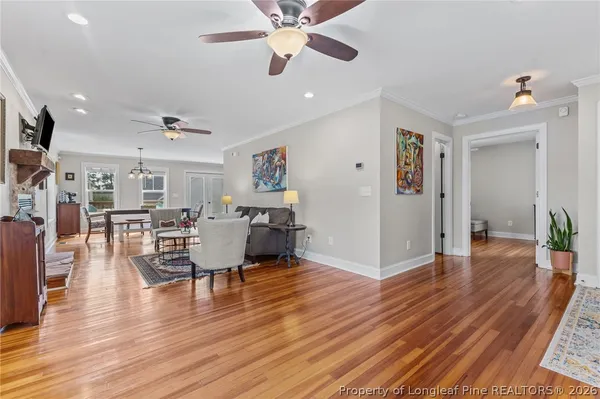 a kitchen with stainless steel appliances granite countertop a refrigerator a oven and a wooden floors