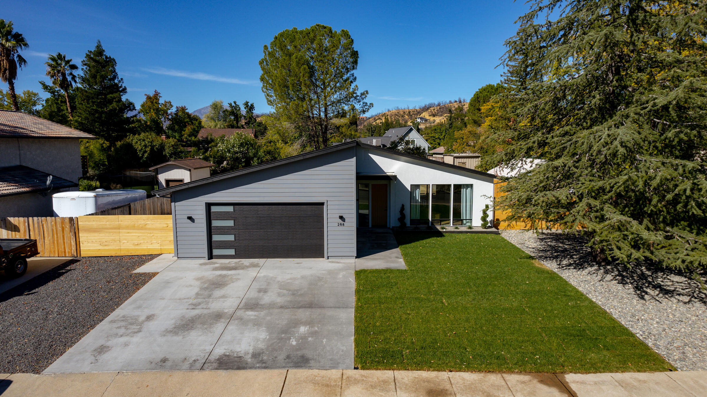 288 Tourmaline Way Redding, CA 96003 - Photo 2 of 46 a front view of a house with yard and green space