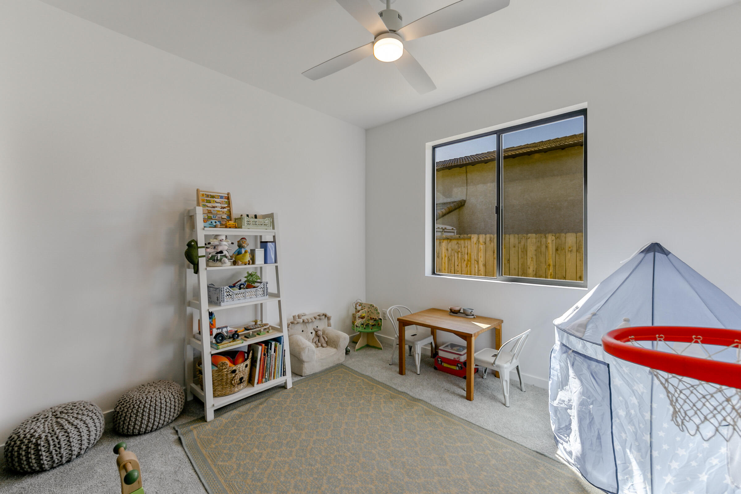 288 Tourmaline Way Redding, CA 96003 - Photo 29 of 46 a bedroom with filled bed and a window