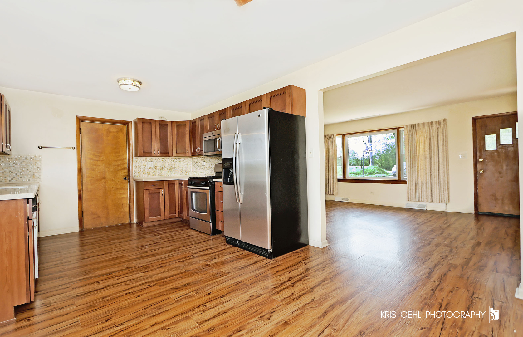 24260 Town Line Road Lake Villa, IL 60046 - Photo 6 of 20 a kitchen with stainless steel appliances a refrigerator and wooden floor