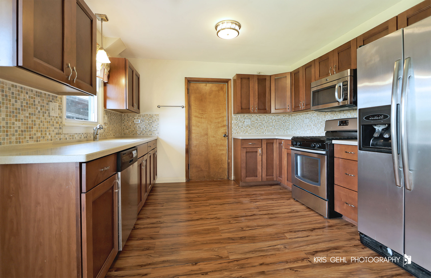 24260 Town Line Road Lake Villa, IL 60046 - Photo 7 of 20 a kitchen with stainless steel appliances granite countertop a refrigerator a stove top oven a sink and dishwasher