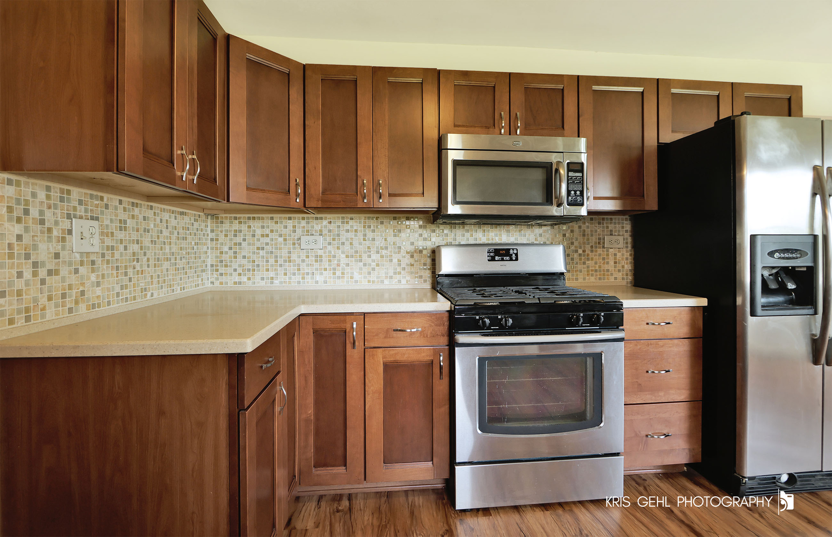 24260 Town Line Road Lake Villa, IL 60046 - Photo 8 of 20 a kitchen with granite countertop a stove and a microwave with cabinets