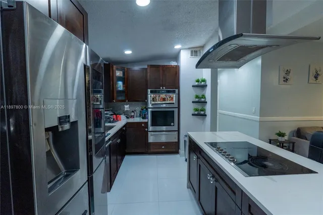 a kitchen with refrigerator and cabinets