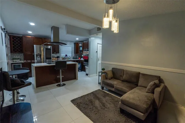 a living room with furniture and a chandelier