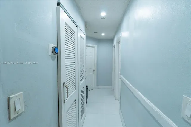 a view of hallway with stairs and a shower