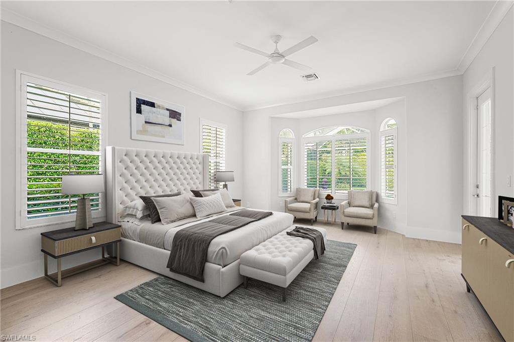 425 Rudder Road Naples, FL 34102 - Photo 12 of 31 a bedroom with a bed couch and a window