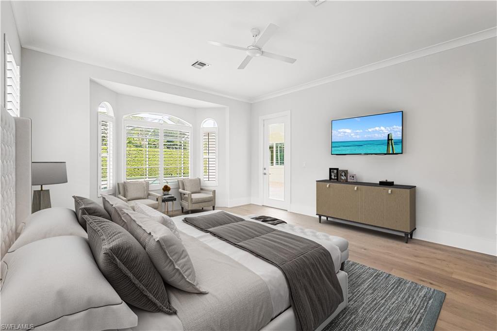 425 Rudder Road Naples, FL 34102 - Photo 13 of 31 a bedroom with a bed and a night stand