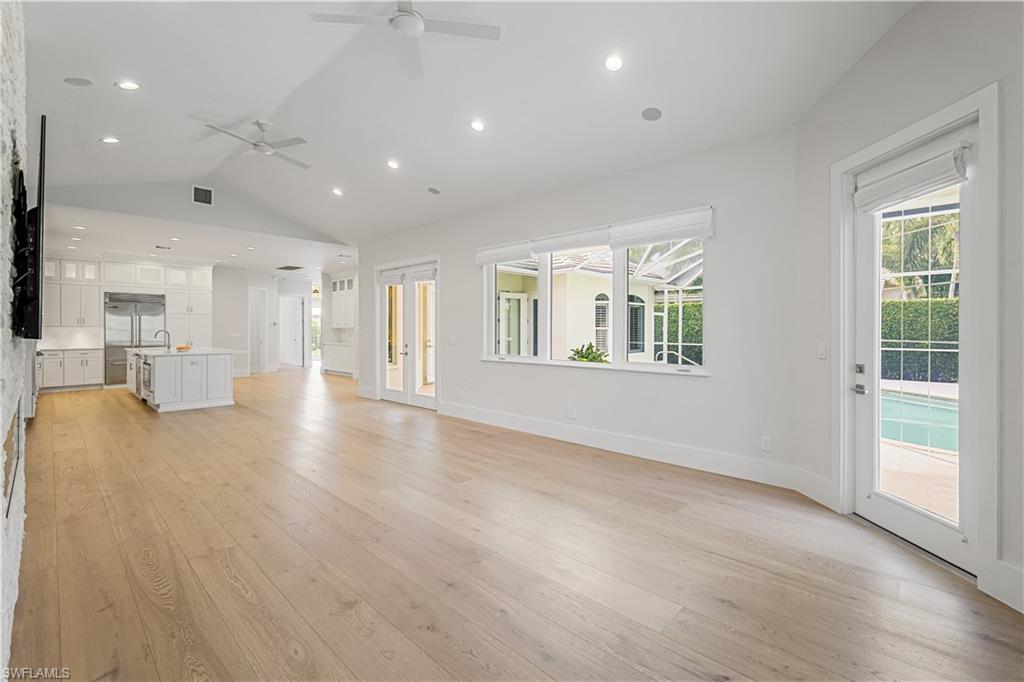 425 Rudder Road Naples, FL 34102 - Photo 16 of 31 an empty room with wooden floor and windows