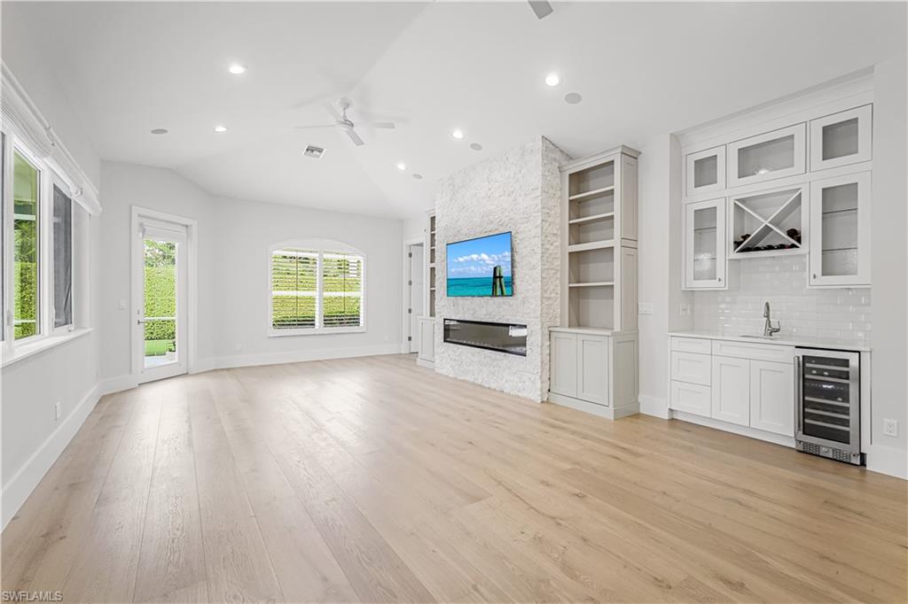 425 Rudder Road Naples, FL 34102 - Photo 19 of 31 a view of an empty room with a window and wooden floor
