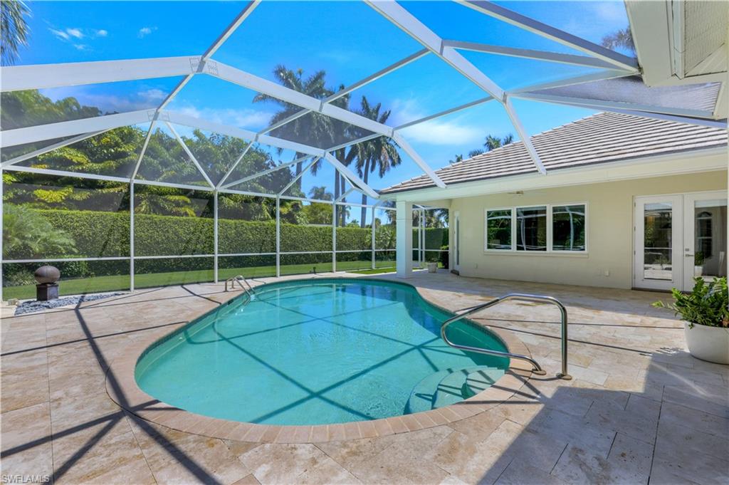 425 Rudder Road Naples, FL 34102 - Photo 29 of 31 a view of a backyard with a ceiling fan and porch