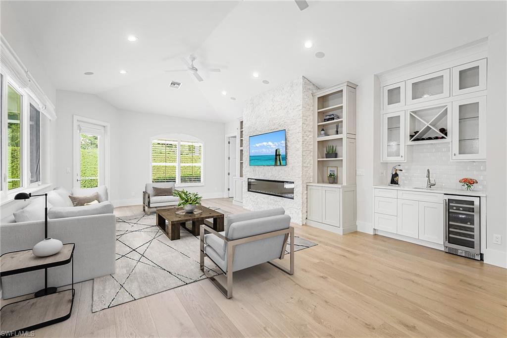 425 Rudder Road Naples, FL 34102 - Photo 6 of 31 a living room with furniture window and wooden floor