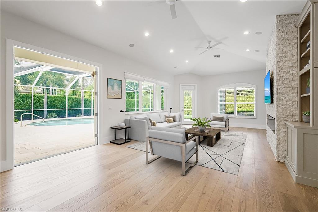 425 Rudder Road Naples, FL 34102 - Photo 7 of 31 a living room with furniture and a large window