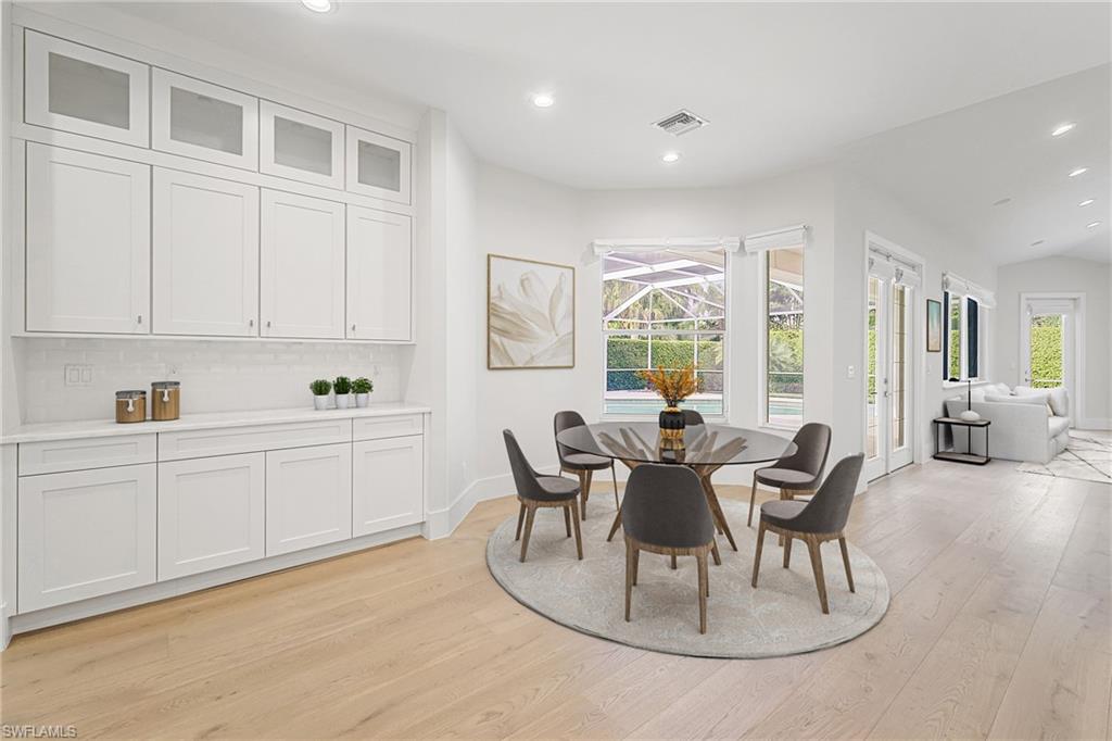 425 Rudder Road Naples, FL 34102 - Photo 9 of 31 a view of a dining room with furniture and wooden floor