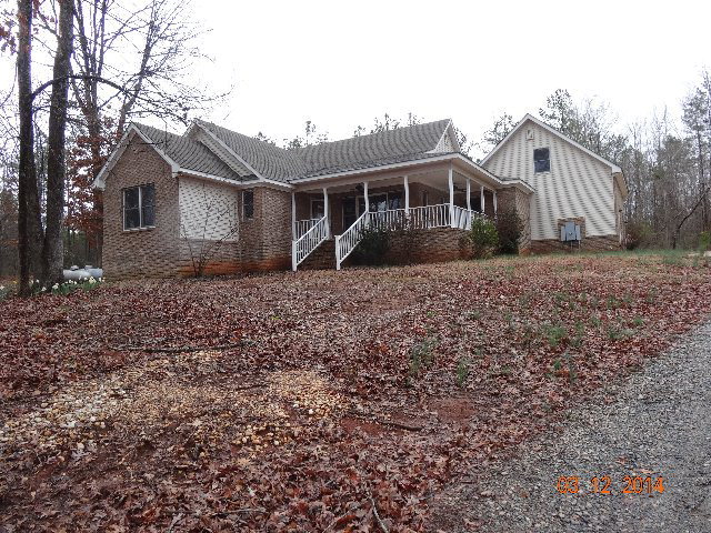407 Genie Ethridge Road, Unit 1 Gray, GA 31032 - Photo 1 of 8 a front view of a house with a yard