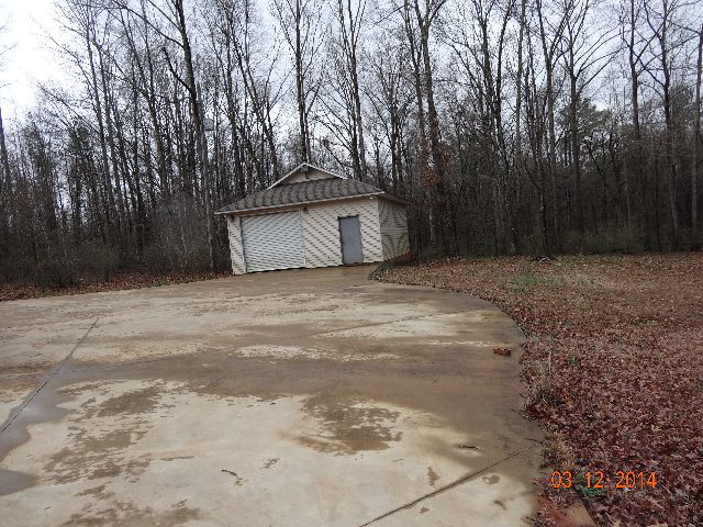 407 Genie Ethridge Road, Unit 1 Gray, GA 31032 - Photo 2 of 8 a house with trees in front of it