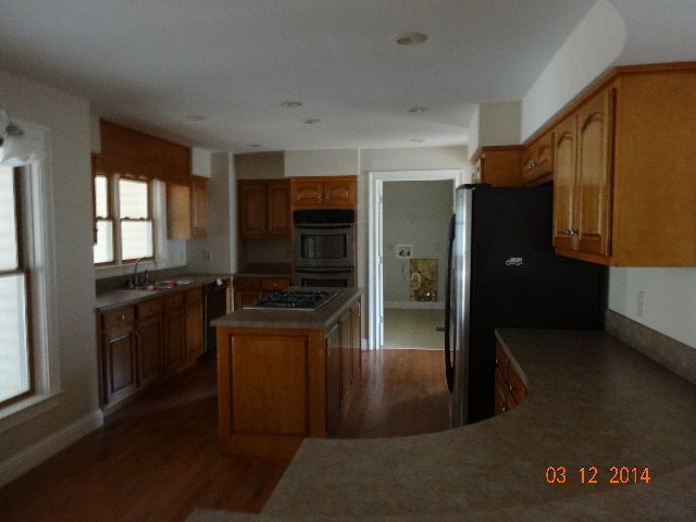 407 Genie Ethridge Road, Unit 1 Gray, GA 31032 - Photo 3 of 8 a kitchen with granite countertop a refrigerator and a stove