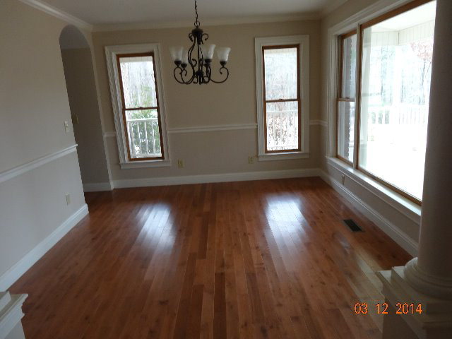 407 Genie Ethridge Road, Unit 1 Gray, GA 31032 - Photo 4 of 8 a view of an empty room with wooden floor and a window