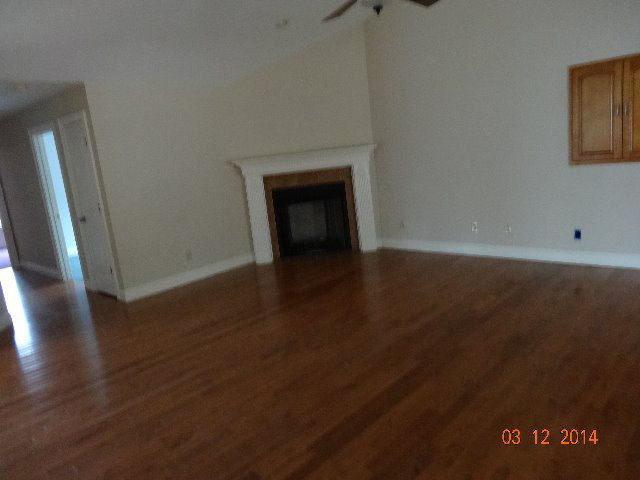 407 Genie Ethridge Road, Unit 1 Gray, GA 31032 - Photo 5 of 8 a view of an empty room with wooden floor and a window