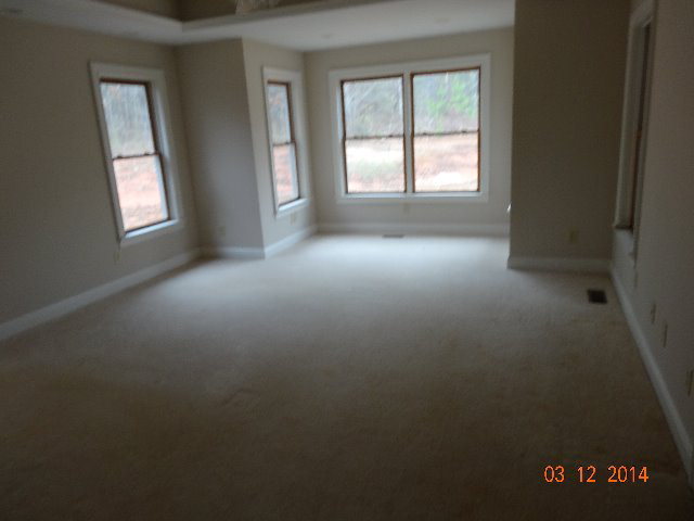 407 Genie Ethridge Road, Unit 1 Gray, GA 31032 - Photo 7 of 8 an empty room with windows