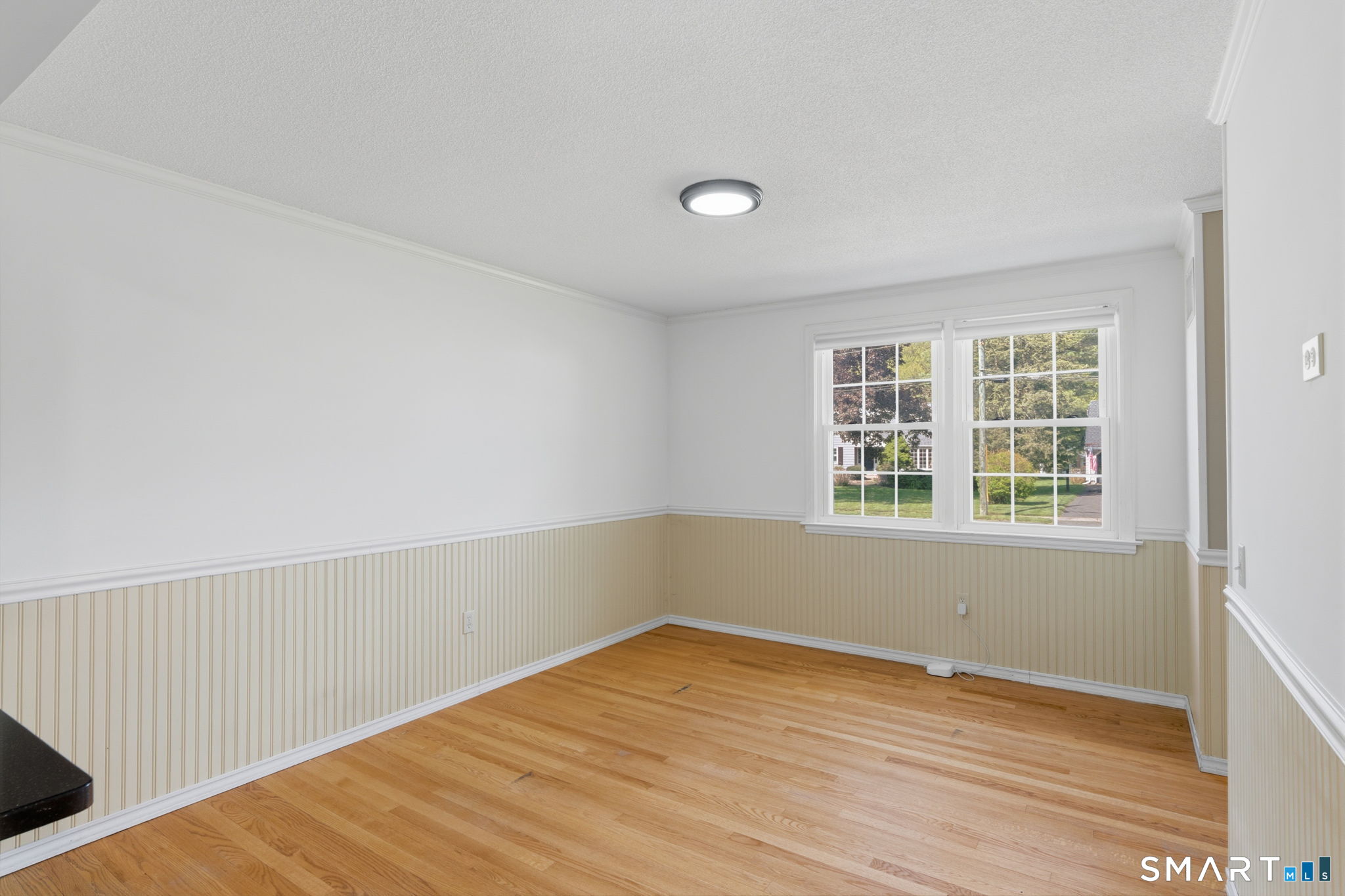 32 Meadowgate Street Wethersfield, CT 06109 - Photo 14 of 40 an empty room with wooden floor and windows