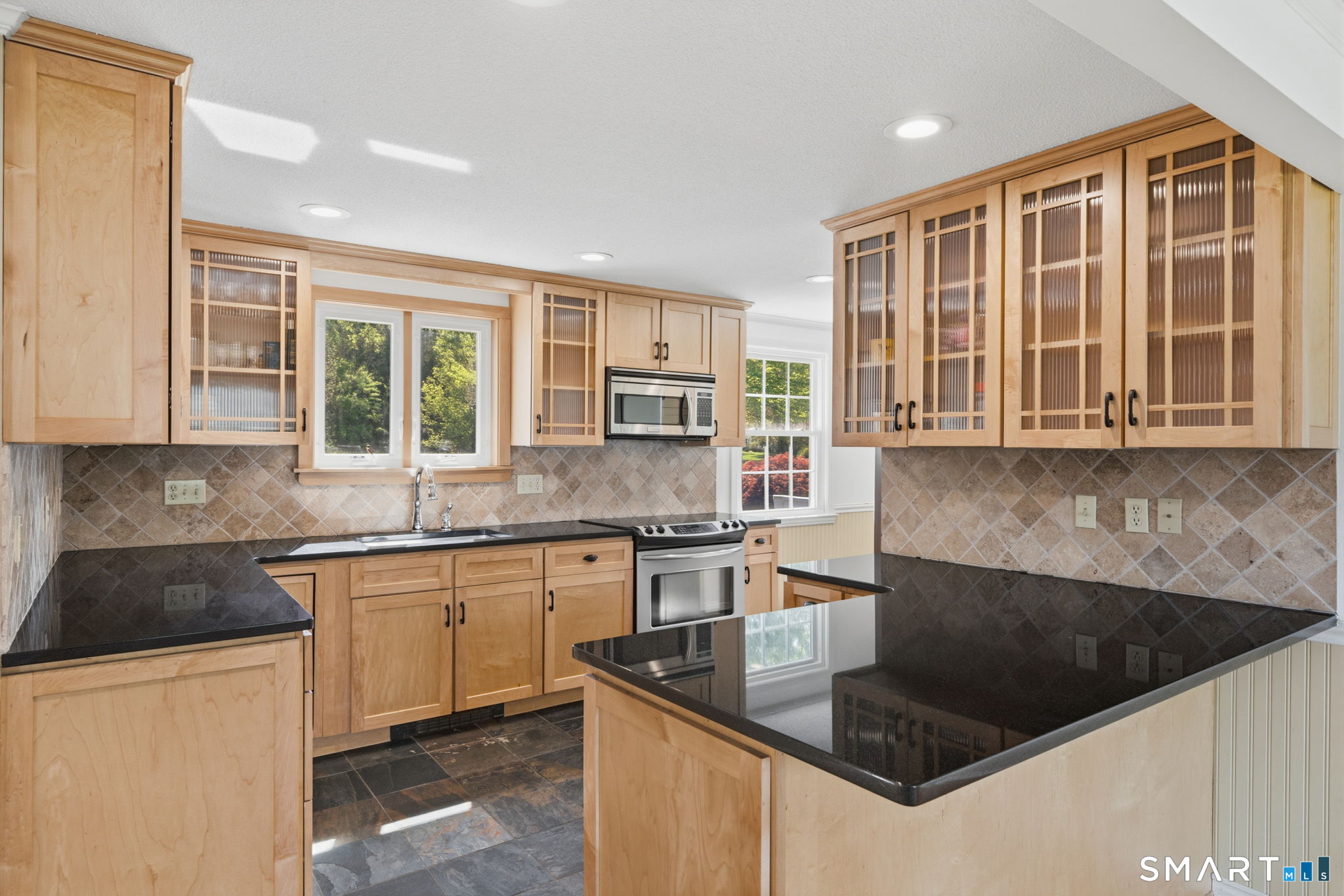 32 Meadowgate Street Wethersfield, CT 06109 - Photo 15 of 40 a kitchen with stainless steel appliances granite countertop a stove a sink and a granite counter tops with a large window