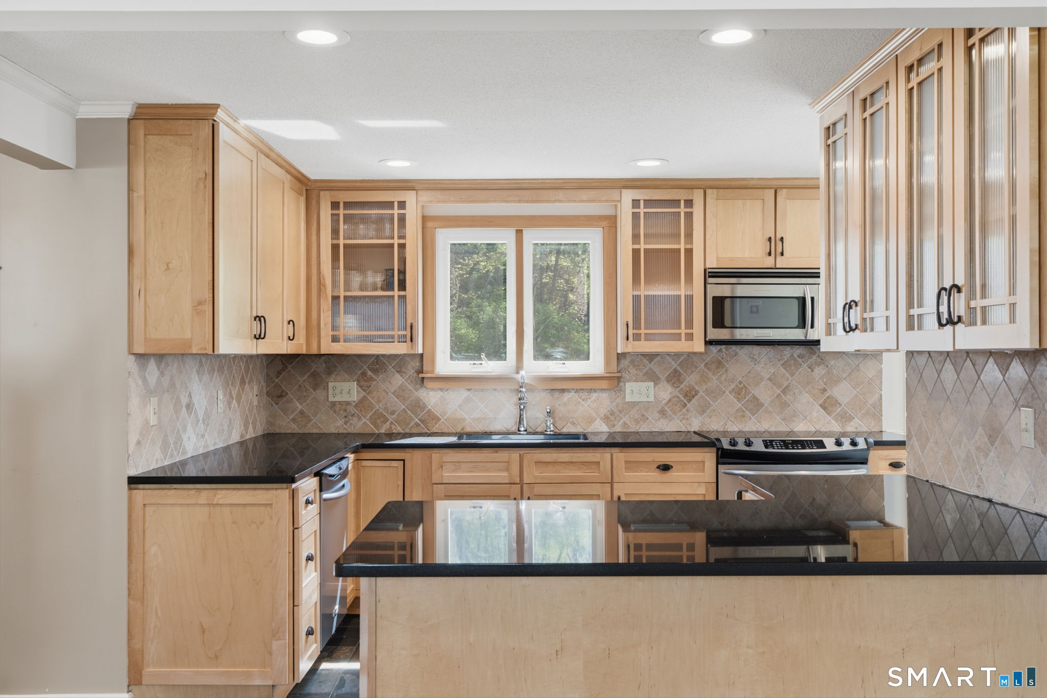 32 Meadowgate Street Wethersfield, CT 06109 - Photo 16 of 40 a kitchen with stainless steel appliances granite countertop a stove a sink and a microwave