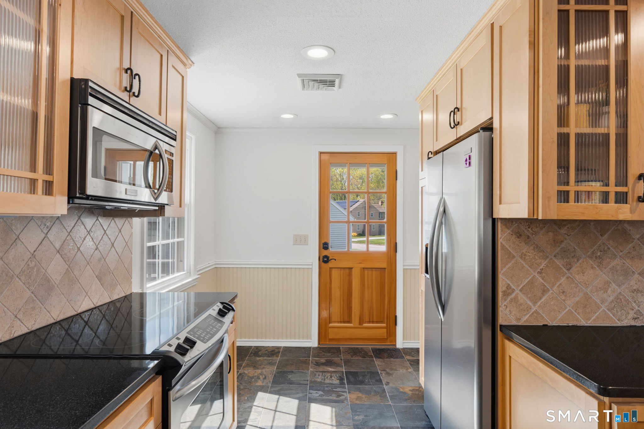 32 Meadowgate Street Wethersfield, CT 06109 - Photo 19 of 40 a kitchen with stainless steel appliances granite countertop a refrigerator and a sink