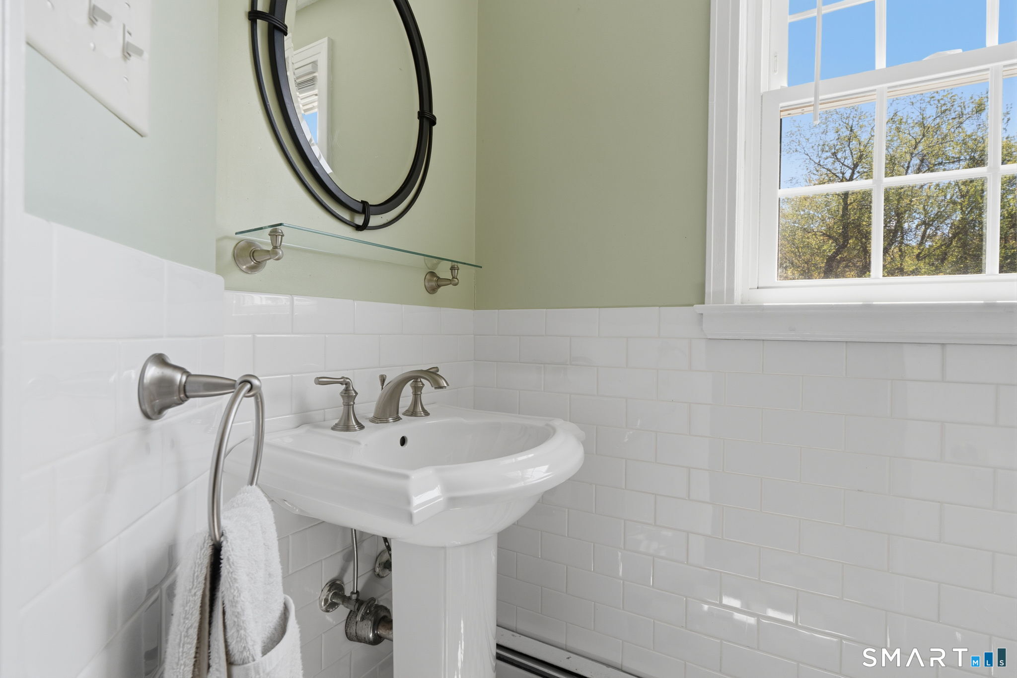 32 Meadowgate Street Wethersfield, CT 06109 - Photo 30 of 40 a bathroom with a sink a mirror and a window
