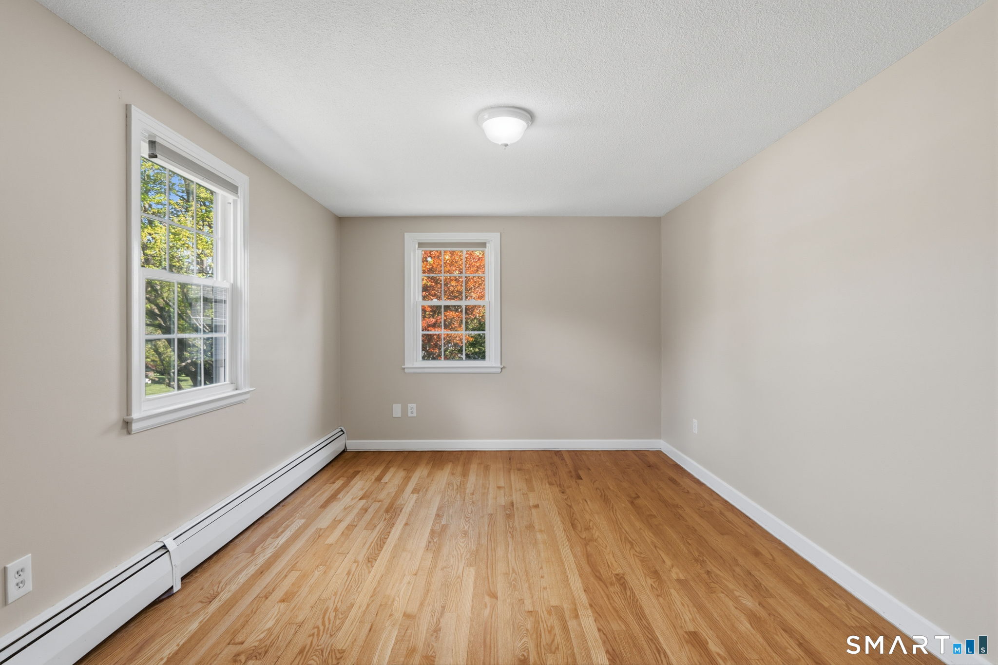 32 Meadowgate Street Wethersfield, CT 06109 - Photo 32 of 40 an empty room with wooden floor and windows