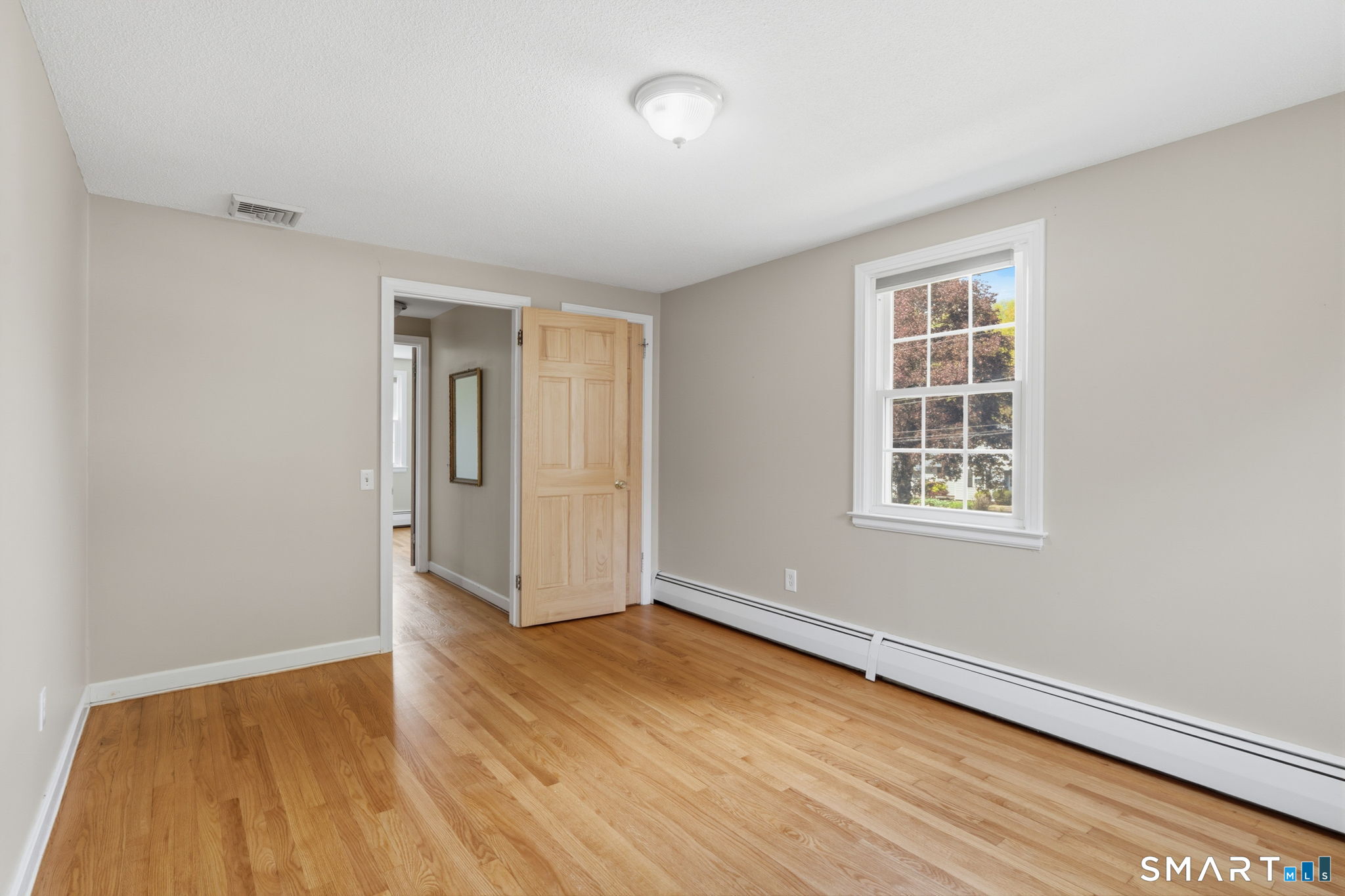 32 Meadowgate Street Wethersfield, CT 06109 - Photo 33 of 40 an empty room with wooden floor and windows
