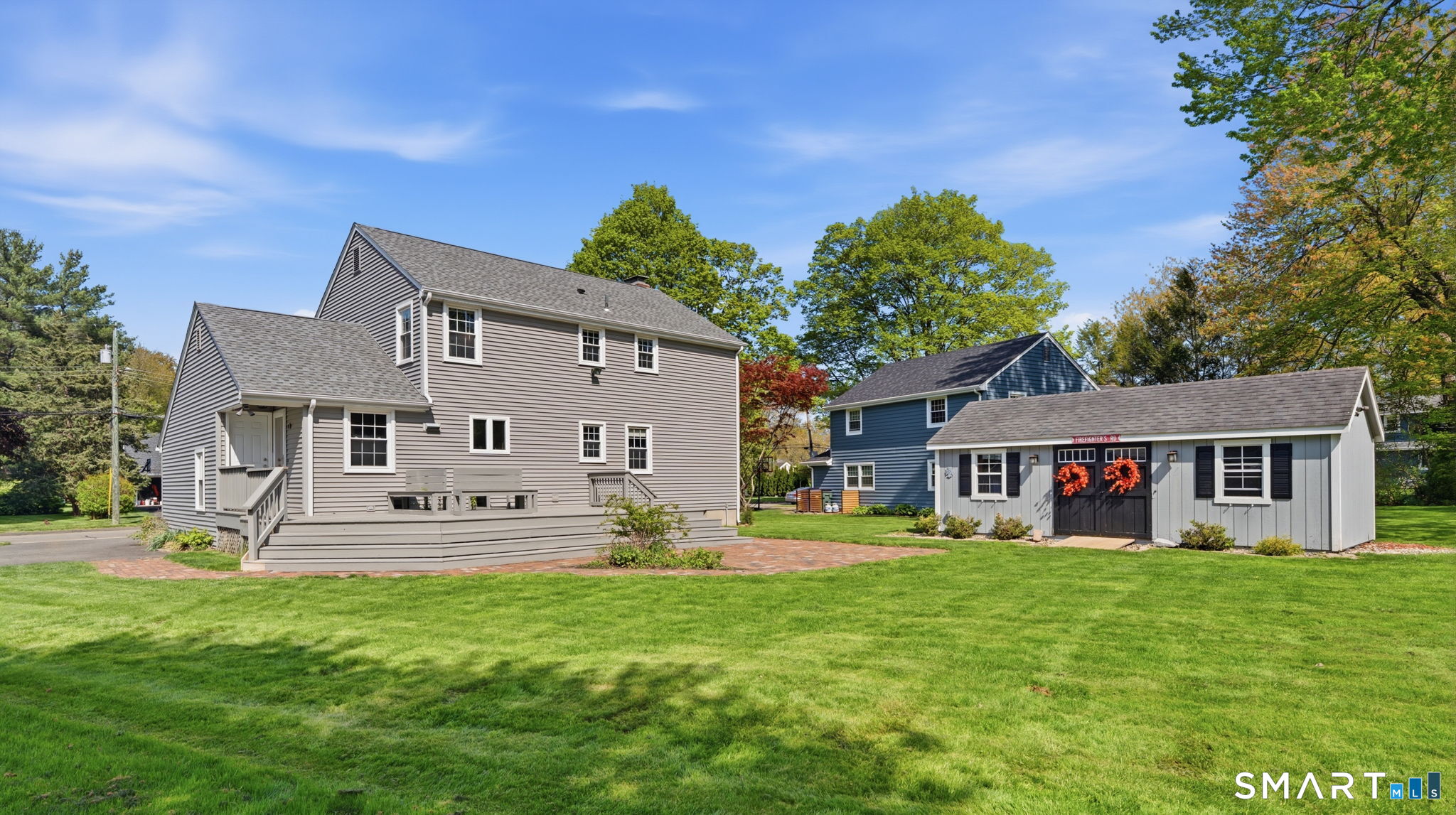 32 Meadowgate Street Wethersfield, CT 06109 - Photo 5 of 40 a front view of a house with a yard table and chairs