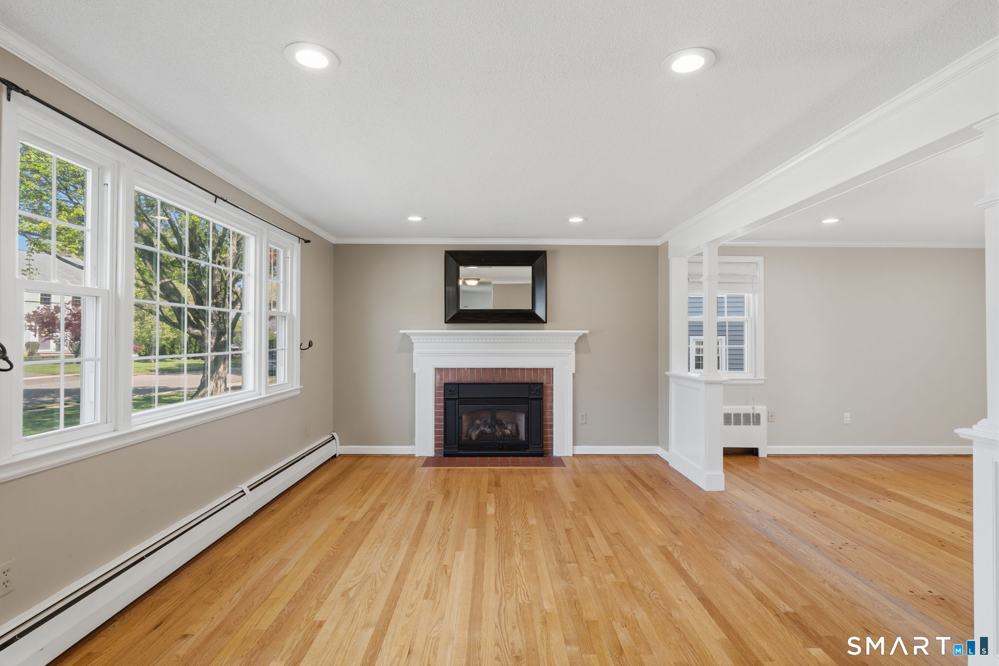 32 Meadowgate Street Wethersfield, CT 06109 - Photo 8 of 40 an empty room with windows and fireplace