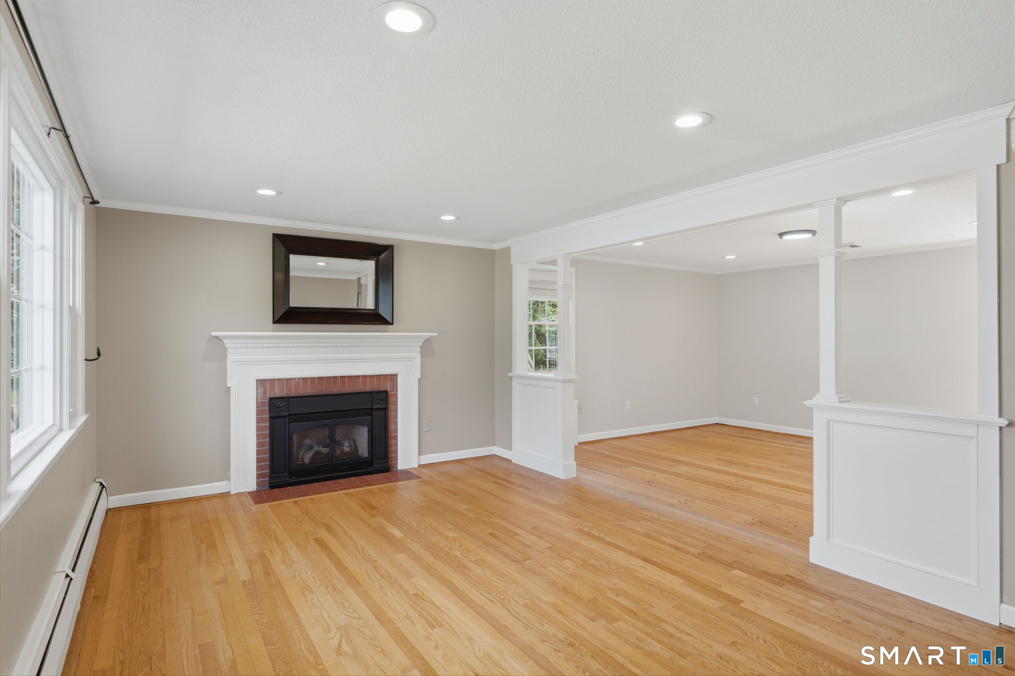 32 Meadowgate Street Wethersfield, CT 06109 - Photo 10 of 40 a view of empty room with wooden floor and fireplace