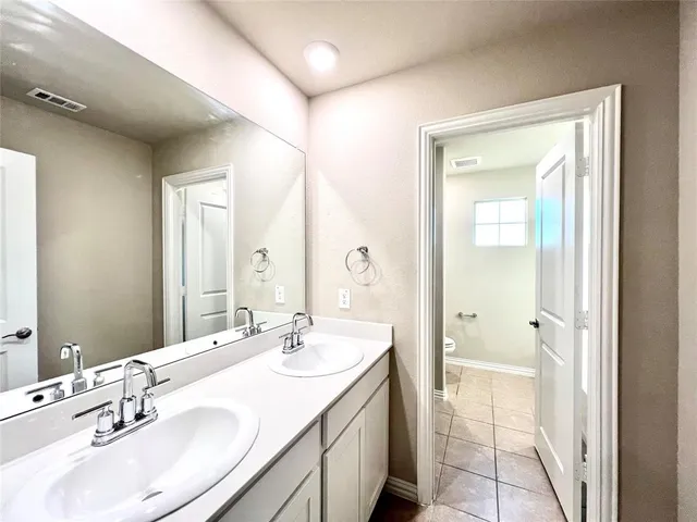a bathroom with a sink double vanity and a mirror