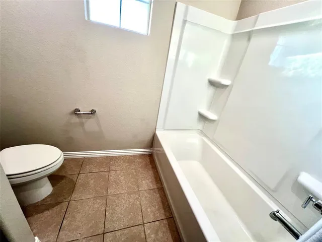 a bathroom with a toilet and a bathtub