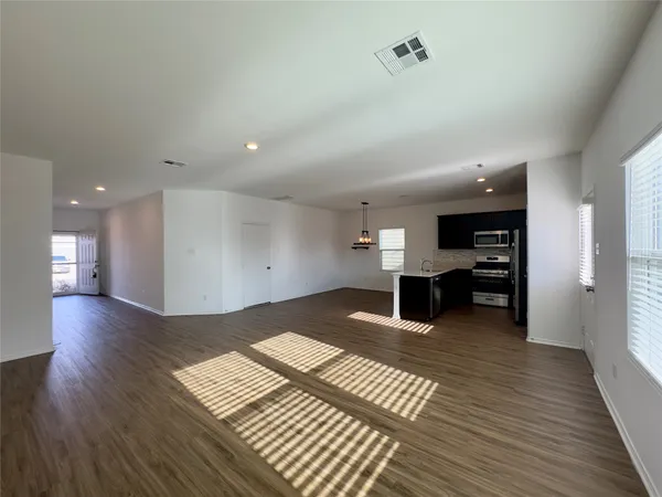 a view of a living room with wooden floor