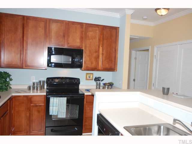 537 Weather Ridge Lane Cary, NC 27513 - Photo 5 of 12 Lots of Room in this Kitchen w/ Tall Cabinets, Extra Counter Space w/ Large Island which features a built-in sink & dishwasher!