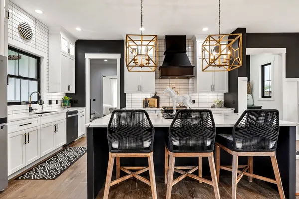 a kitchen with a stove cabinets and a refrigerator