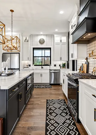 a kitchen with stainless steel appliances granite countertop a stove sink and cabinets
