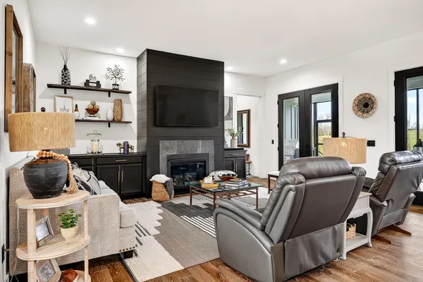 a living room with furniture and a fireplace