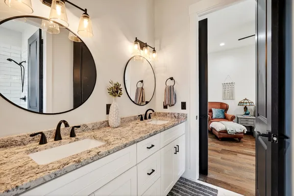 a view of a house with potted plants and a small yard