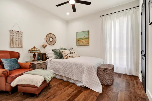 a aerial view of a house next to a lake with a large trees